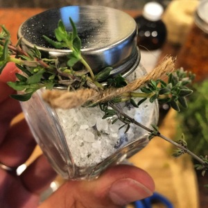 Photo of herb salt in a jar with herbs tied in twine
